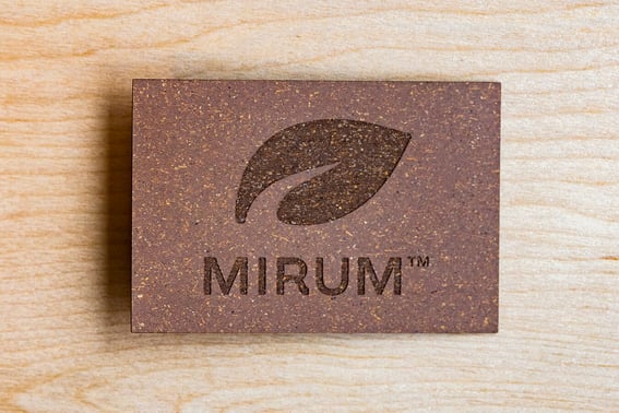 A MIRUM patch on a wooden surface. The patch displays the MIRUM logo.